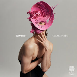 Cover Art for HERETIC, featuring Adam Noviello wearing a pink headdress covering his face