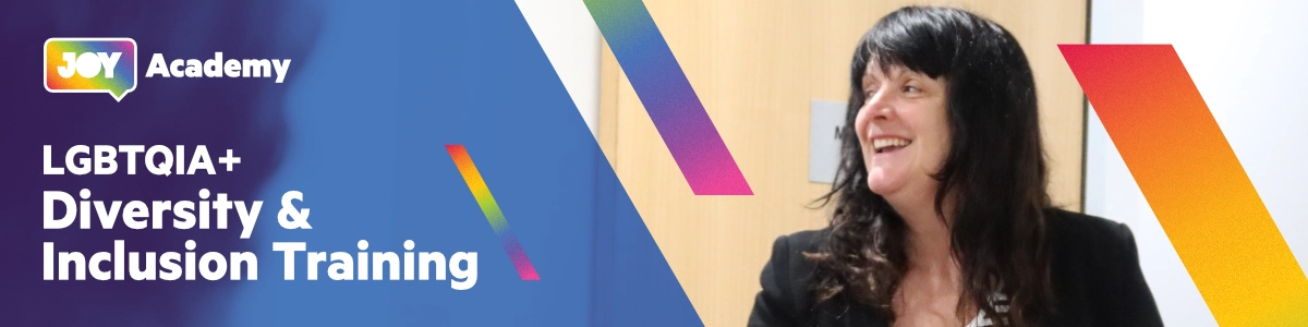 A graphic which says "LGBTQIA+ Diversity and Inclusion Training" alongside an image of JOY Academy head Fiona laughing during a training session. Rainbow bands bounce in from the sides of the image.