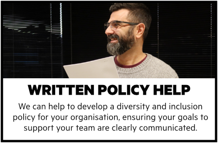 Written policy help. We can help to develop a diversity and inclusion policy for your organisation, ensuring your goals to support your team are clearly communicated. Image of a man with a beard and glasses smiling holding a neatly stapled document.