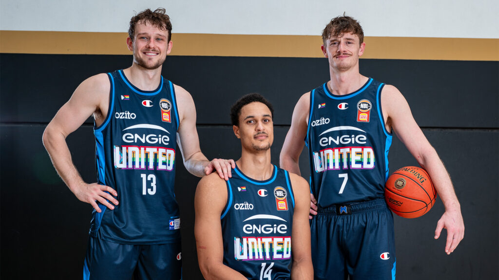 Melbourne United players Tanner Krebs, Jesse Edwards and Finn Delaney show off Melbourne United's 2026 Pride Round jersey.